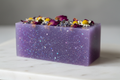 purple bar soap with glitter and flower topping